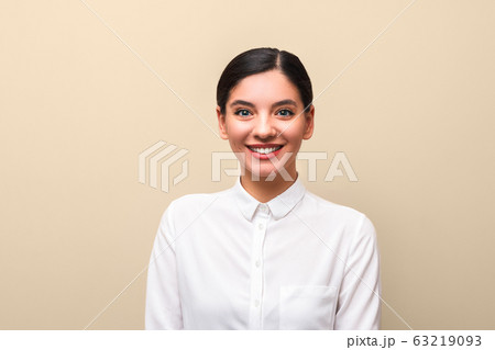 young attractive student female in white shirt with collar, tied hairs and red lips cheerful smiling. successful university enrolment 63219093