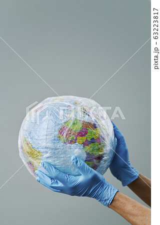 doctor with a world globe wrapped in plastic. doctor with a world globe wrapped in plastic. 63223817