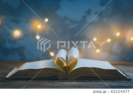 Old opened book, heart shaped paper sheets, dark Old opened book, heart shaped paper sheets, dark 63224377