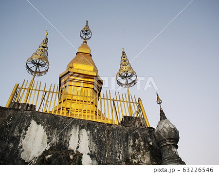 reflect sunlight at the buddhism golden stupa: PHU-SI or PHOUSI monument under twilight sky at evening time in LUANG PRABANG, LAOS 63226546
