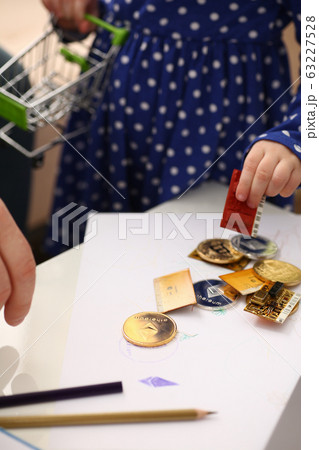 Little girl arm collecting crypto coins 63227528