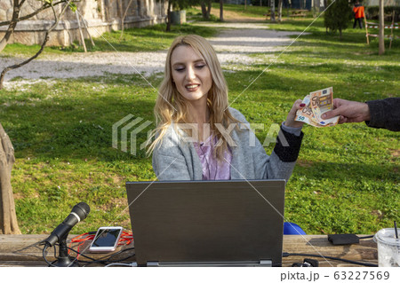 Female blond blogger receiving money from Female blond blogger receiving money from 63227569