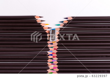 Decorative backdrop from colored pencils in the shape of opened zip on a white background. 63229397