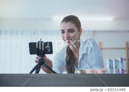 Young woman blogger showing in front of camera to 63231486