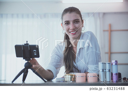 Beautiful young girl blogger is live streaming. 63231488