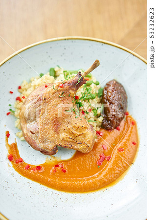 Plate Duck leg su-vide, with bulgur and onion marmalade. Barbecue restaurant menu, a series of photos of different meats 63232623