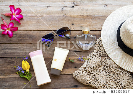 sunscreen spf50, body lotion, perfume, sunglasses, hat and knitting of lifestyle woman relax arrangement flat lay style sunscreen spf50, body lotion, perfume, sunglasses, hat and knitting of lifestyle woman relax arrangement flat lay style 63239617