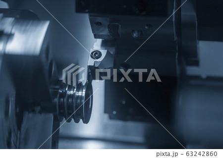 The CNC lathe machine groove cutting the pulley. The CNC lathe machine groove cutting the pulley. 63242860