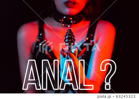 Concept of anal sex. Butt plug in the hands of a girl 63245323