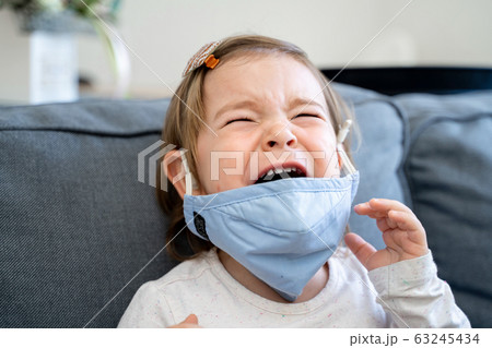 Toddler girl with medical mask on the face. Covid 2019 corona virus outbreak 63245434