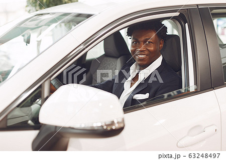 Handsome and elegant black man in a car salon 63248497