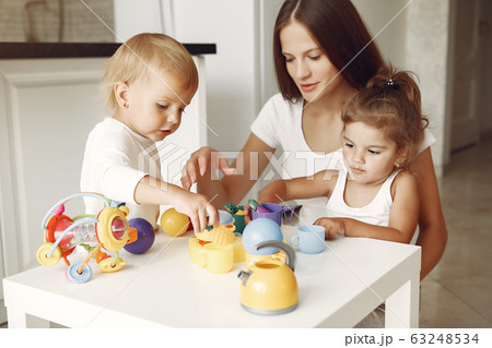 Mother with two children playing in a bathroom Mother with two children playing in a bathroom 63248534