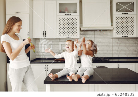 Beautiful family spend time in a kitchen Beautiful family spend time in a kitchen 63248535