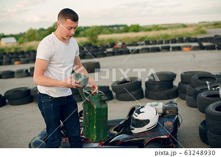 Handsome man in a karting with a car Handsome man in a karting with a car 63248930