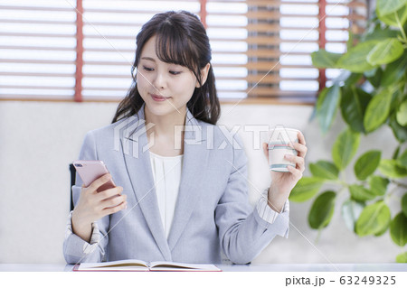オフィスでコーヒーを飲むビジネスウーマン 63249325
