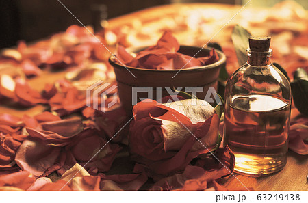 Clay bowl and aroma oil glass bottle among roses petals on the wooden table, natural raw material, selected focus Clay bowl and aroma oil glass bottle among roses petals on the wooden table, natural raw material, selected focus 63249438