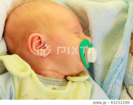 Closeup of little newborn sleeping with teat in Closeup of little newborn sleeping with teat in 63252290