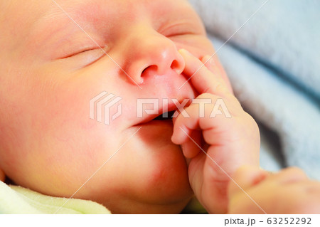 Little newborn baby sleeping in pajamas 63252292