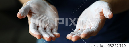 Male hands smeared with magnesium powder ready to workout 63252540
