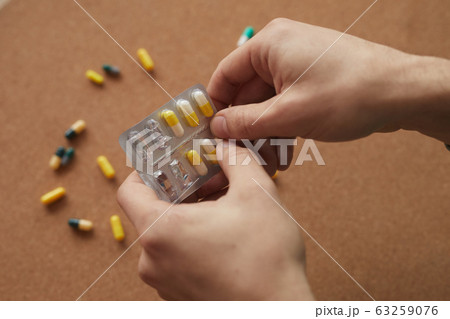 Man drinking pills Man drinking pills 63259076