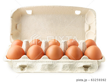 Open tray container of chicken eggs on a white 63259392