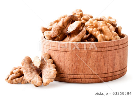 Peeled walnut in a wooden plate on a white 63259394