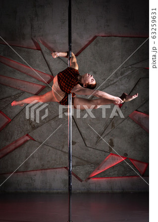 Beautiful girl training on the pole at studio Beautiful girl training on the pole at studio 63259631