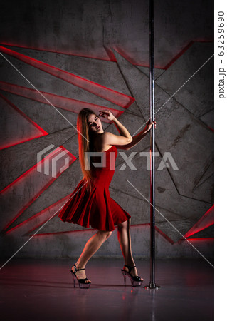 Beautiful girl dancing on the pole at studio Beautiful girl dancing on the pole at studio 63259690