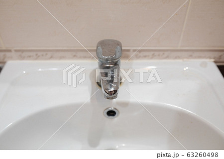 Dirty stainless bathroom tap.Bathroom tap and 63260498