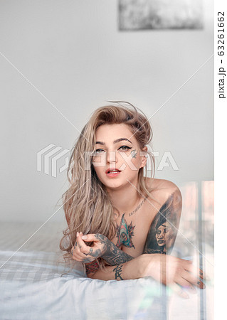 Young adult woman lying on bed at morning 63261662
