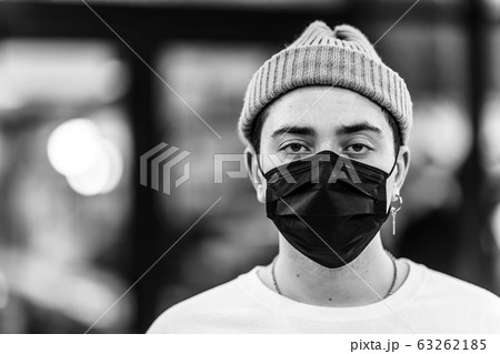 A man puts on a mask from a virus. A man puts on a mask from a virus. 63262185