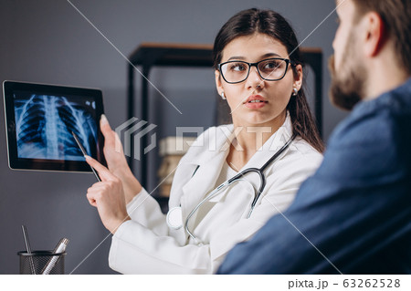 Young Pretty Female MD Using a Tablet Young Pretty Female MD Using a Tablet 63262528