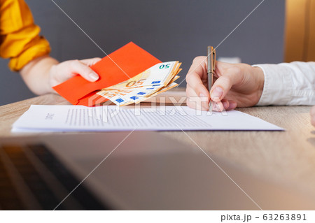Businessman giving money while making deal to agreement a real estate contract and financial corporate Businessman giving money while making deal to agreement a real estate contract and financial corporate 63263891