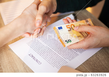 Businessman giving money while making deal to agreement a real estate contract and financial corporate Businessman giving money while making deal to agreement a real estate contract and financial corporate 63263926