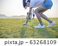 Woman golfer drop a golf ball in the rough area after lost of golf ball out of fairway 63268109