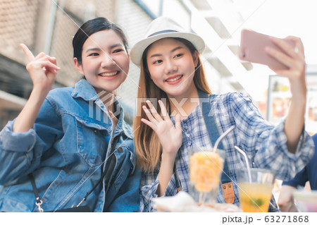 Young Asian female friends taking her vacation and Young Asian female friends taking her vacation and 63271868