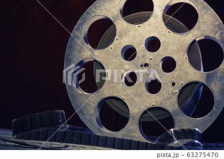 35 mm film reel with dramatic lighting on a dark 35 mm film reel with dramatic lighting on a dark 63275470