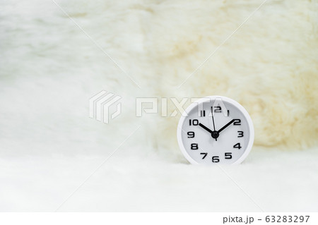 White alarm clock on table 63283297