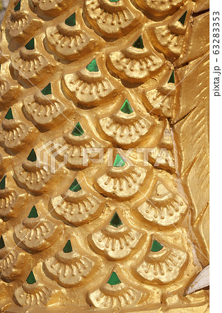 Dragon scales statue. Stucco surface background. 63283353