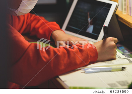 マスクをした子供が自宅でタブレットで学習するシーン / 新型コロナウイルスのイメージ 63283690