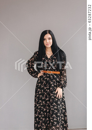 Young brunette model demonstating spring clothes in studio Young brunette model demonstating spring clothes in studio 63287232