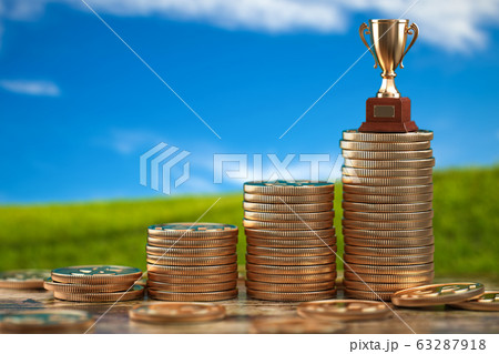Trophy cup on stacks of coin.   Concept of 63287918