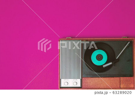 Retro vinyl player and record player on a fuchsia Retro vinyl player and record player on a fuchsia 63289020
