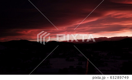 Beautiful dramatic red sunset in winter mountains 63289749