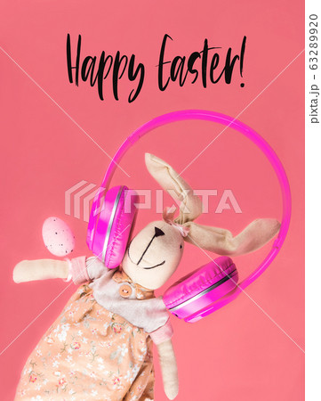 Easter bunny with pink headphones. Holiday concept 63289920