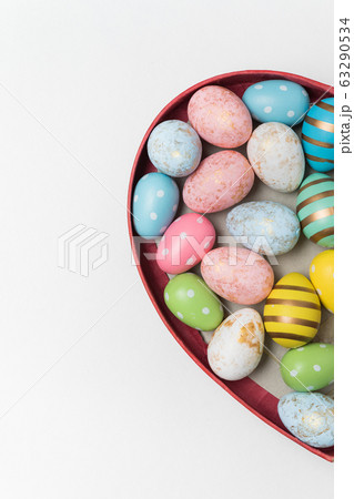 Heart shaped box with Easter eggs on white Heart shaped box with Easter eggs on white 63290534