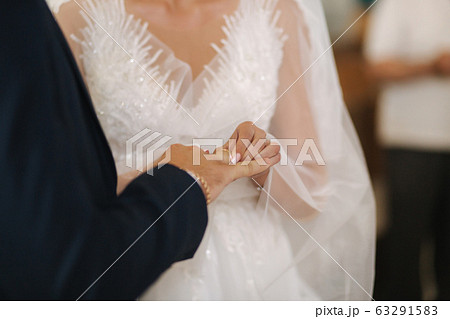Close up hands of groom and bride in the church. wedding Close up hands of groom and bride in the church. wedding 63291583