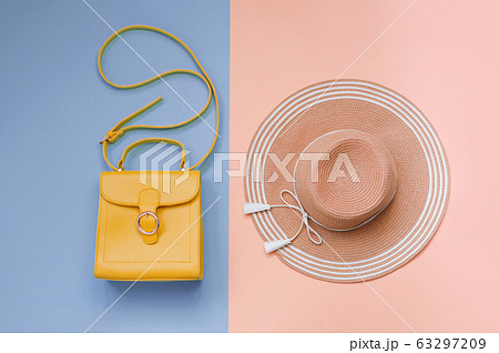 Summer straw hat and orange bag on colorful background. Holiday concept, copyspace 63297209