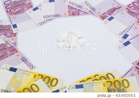 Tablets and euro bills. Expensive medicine concept. Tablets and euro bills. Expensive medicine concept. 63302053