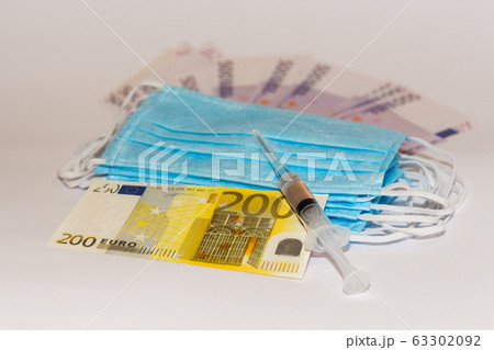 Protective medical mask, syringe vaccine and euro bills. Expensive medicine concept. Protective medical mask, syringe vaccine and euro bills. Expensive medicine concept. 63302092